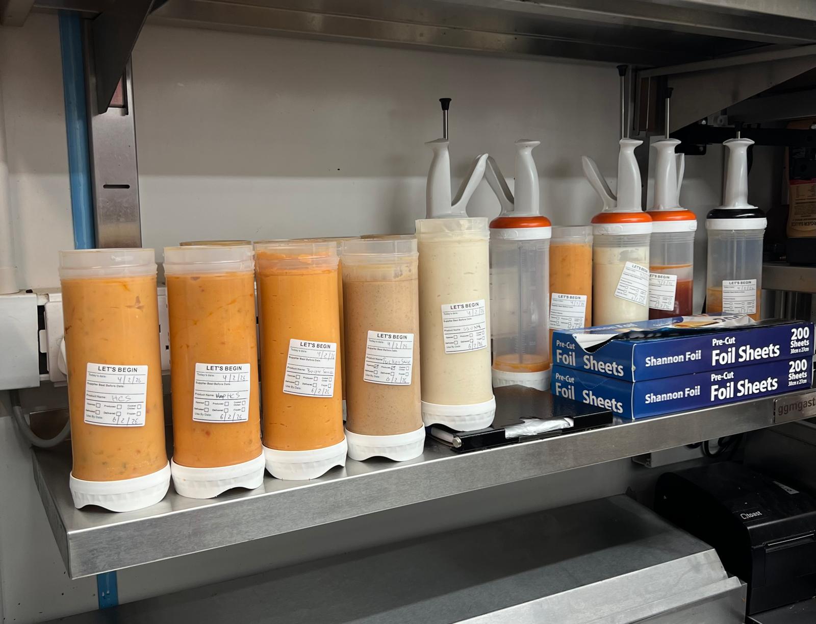 "Waterproof food date label sticker roll"
"Food date labels being applied to container"
"Close-up of easy-peel food date sticker"
"Pack of food date label rolls"