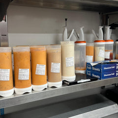 "Waterproof food date label sticker roll"
"Food date labels being applied to container"
"Close-up of easy-peel food date sticker"
"Pack of food date label rolls"